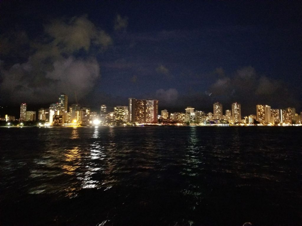 View of the Waikiki coastline at night from the Holokai catamaran.
